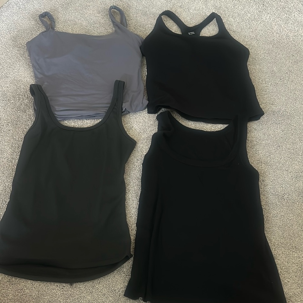 4 large tank tops. 2 with shell bra's, 2 plain tanks